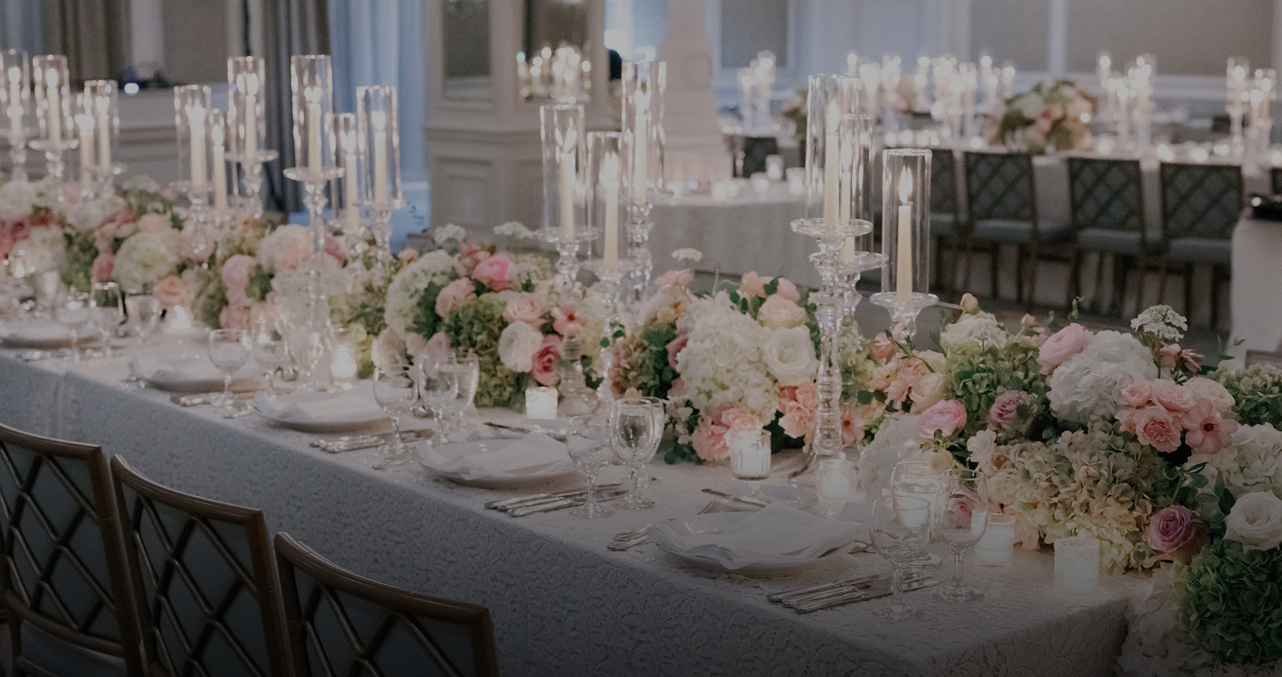 Elegant event table in New Orleans with lush floral centerpieces, crystal candelabras, and fine place settings.