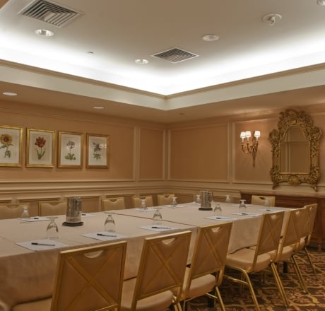 A meeting room with a long table, chairs, and decorative elements.