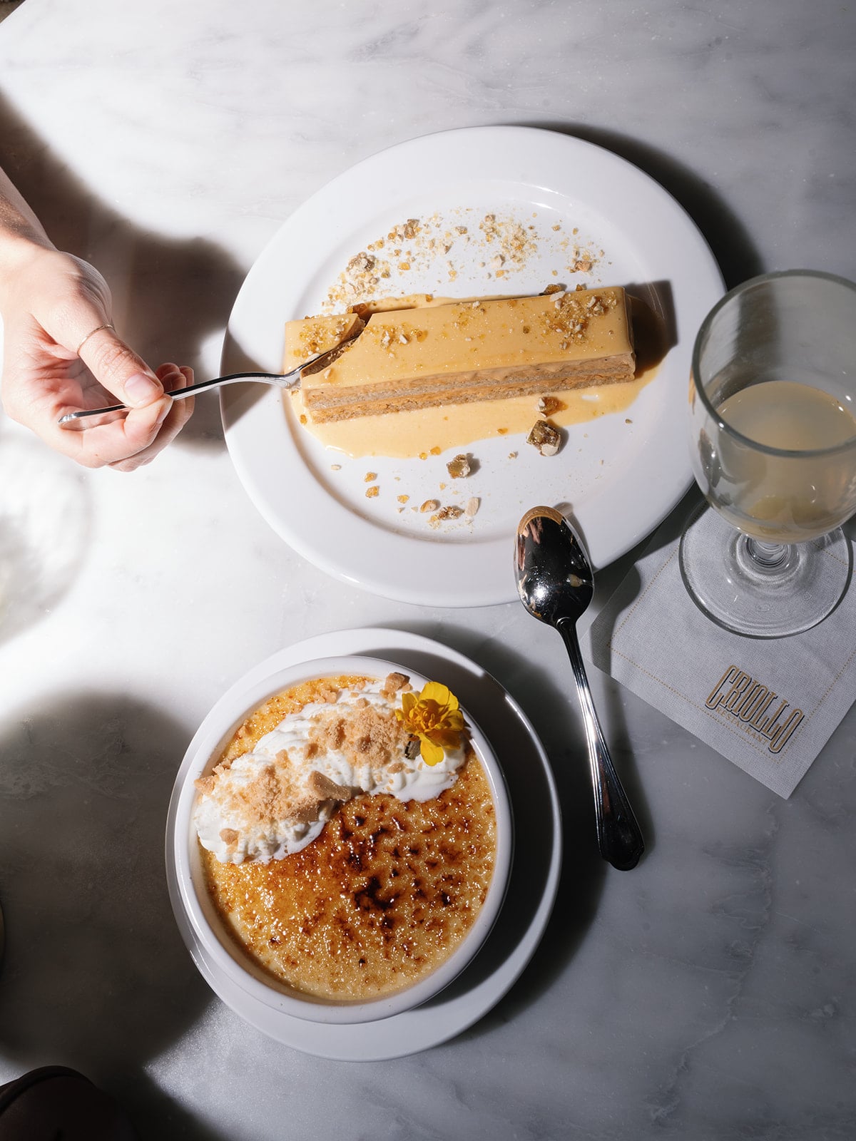 Crème brûlée and layered praline cake from CRILLO Restaurant New Orleans