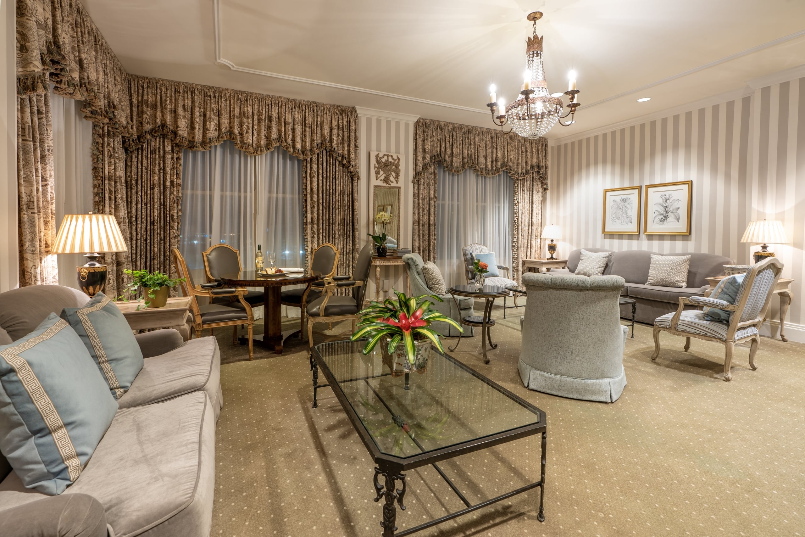 Luxurious New Orleans suite living room with classic decor, sofas, and dining area.