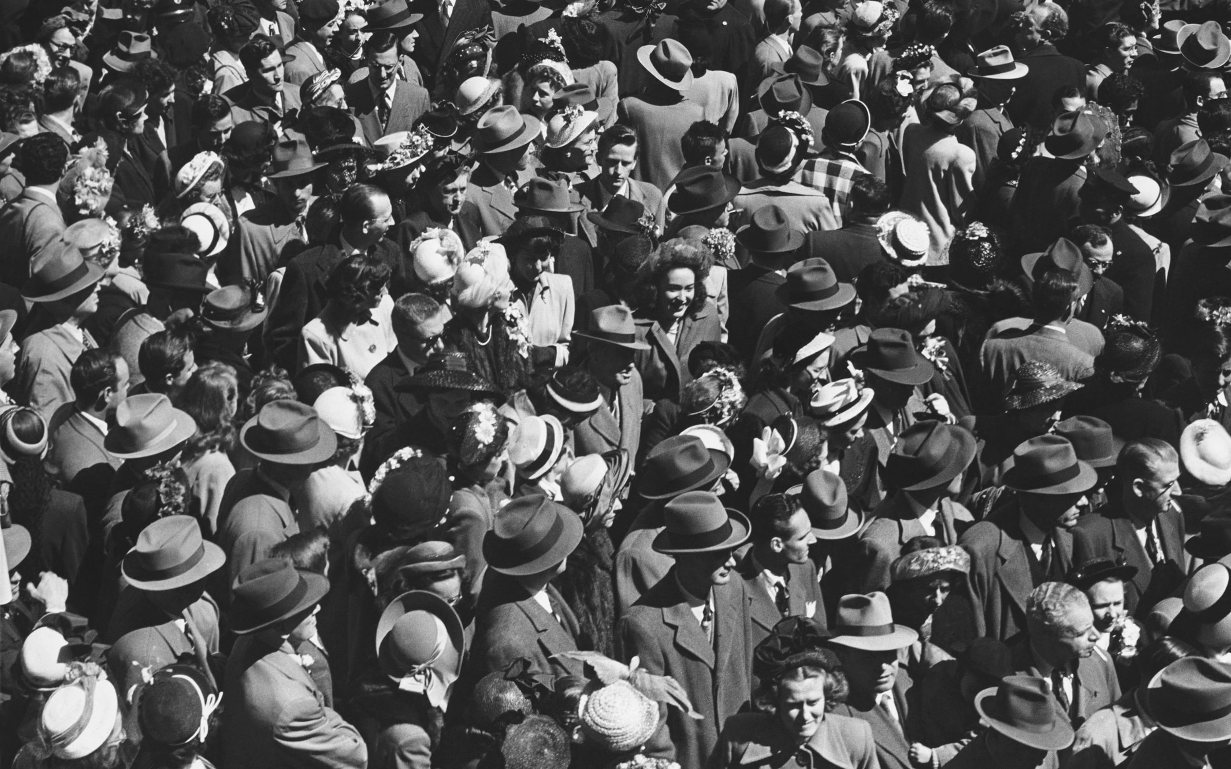 Dense vintage crowd of people wearing hats at a historic New Orleans event