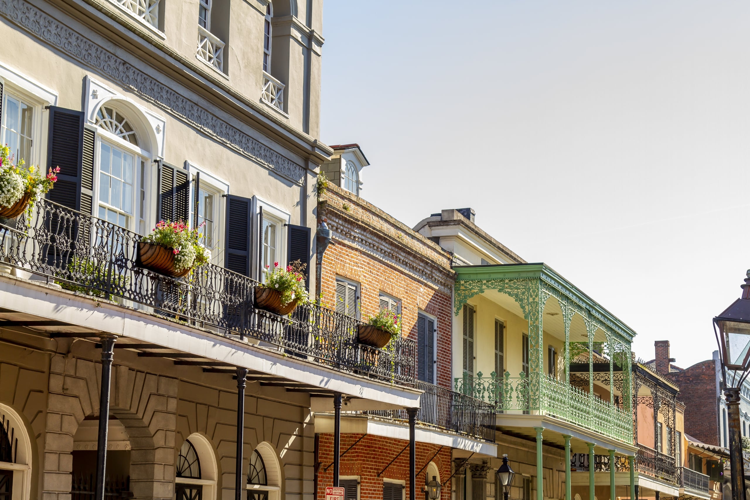 New Orleans, Louisiana in Mardi Gras Carnival Celebrations. New Orleans French Quarter architecture showcasing colorful balconies with intricate ironwork and blooming flowers, capturing the charm of this historic neighborhood