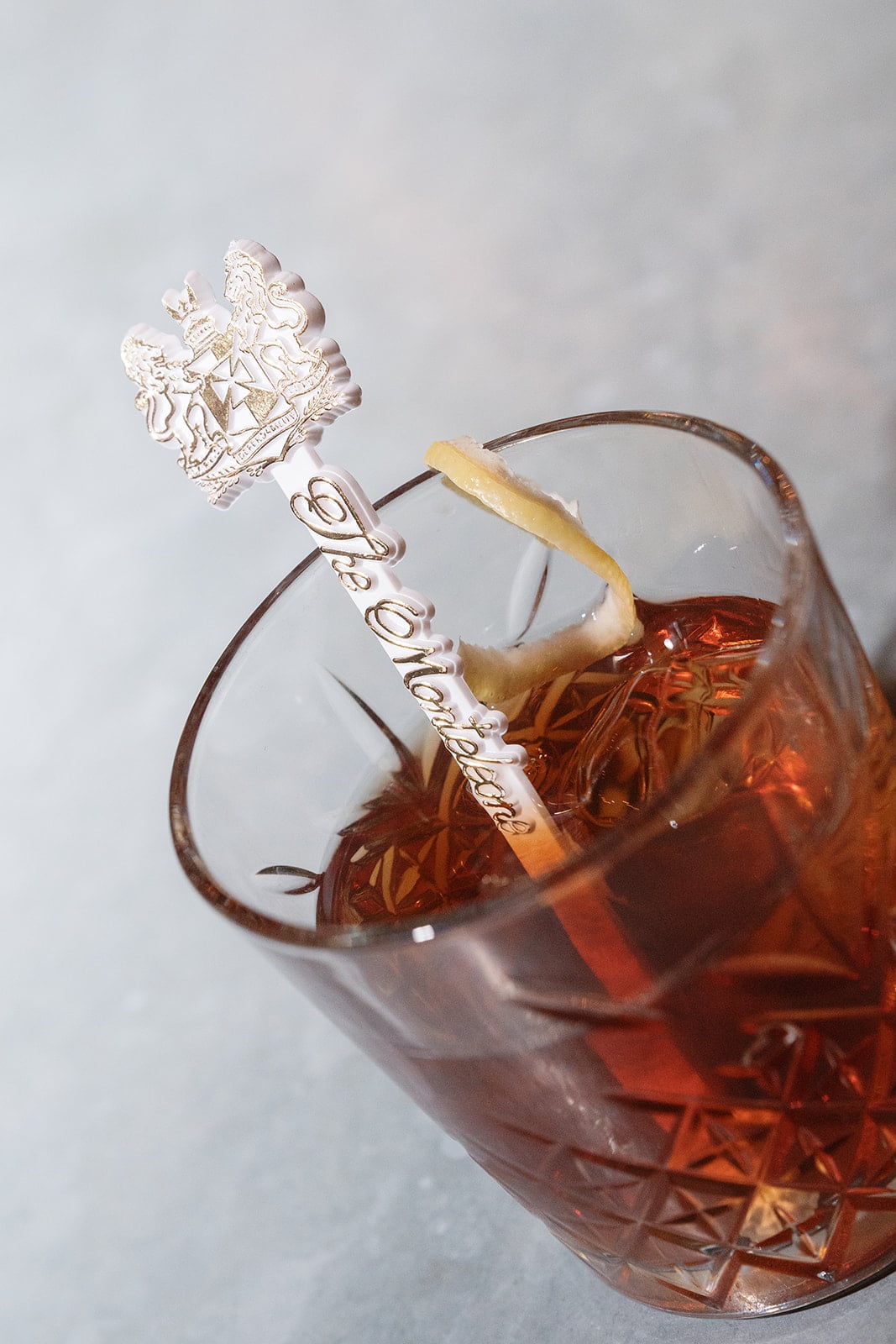 Classic cocktail with a Monteleone Carousel Bar stirring stick and lemon peel, New Orleans.