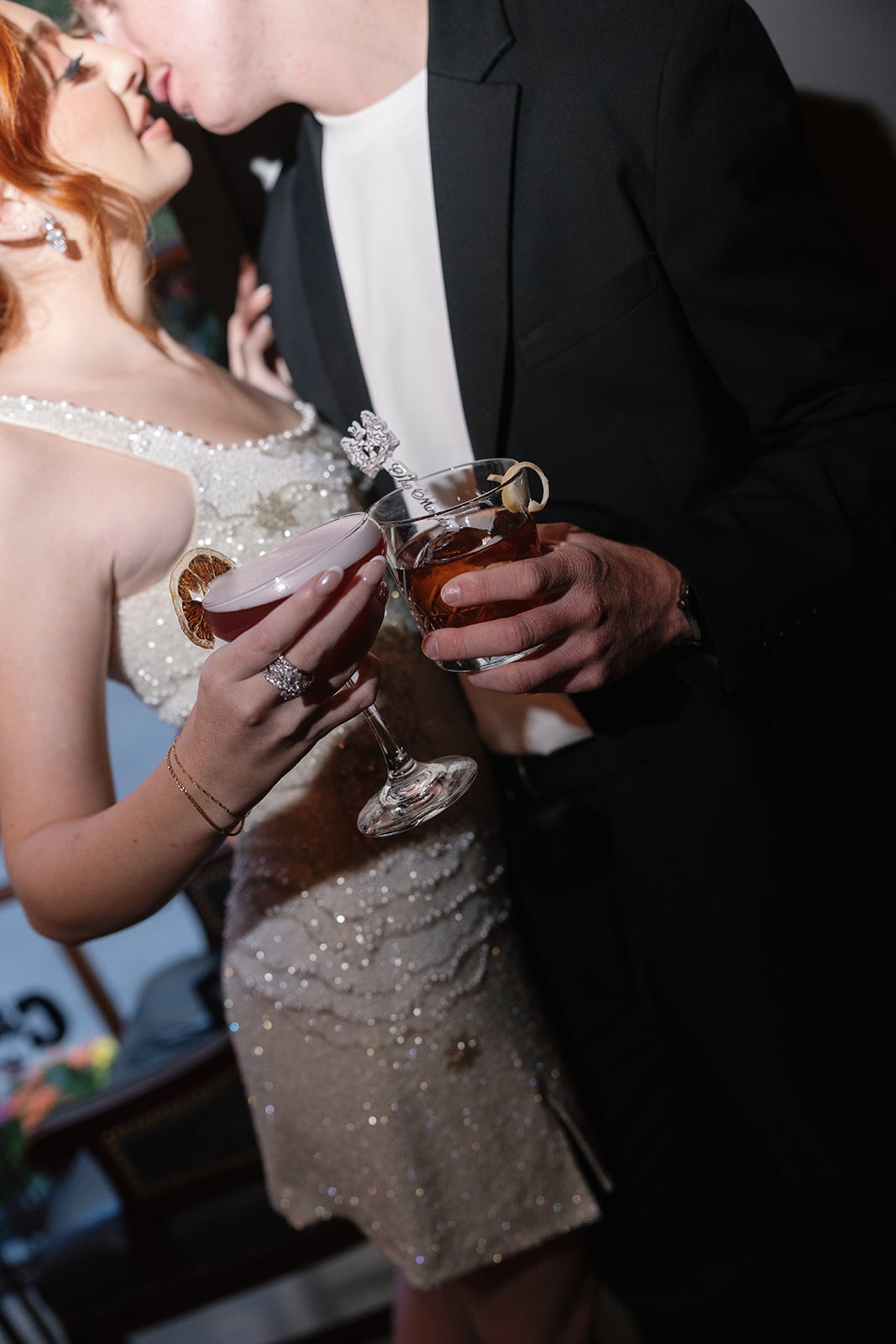 Couple toasting cocktails in an intimate New Orleans setting at The Maison.