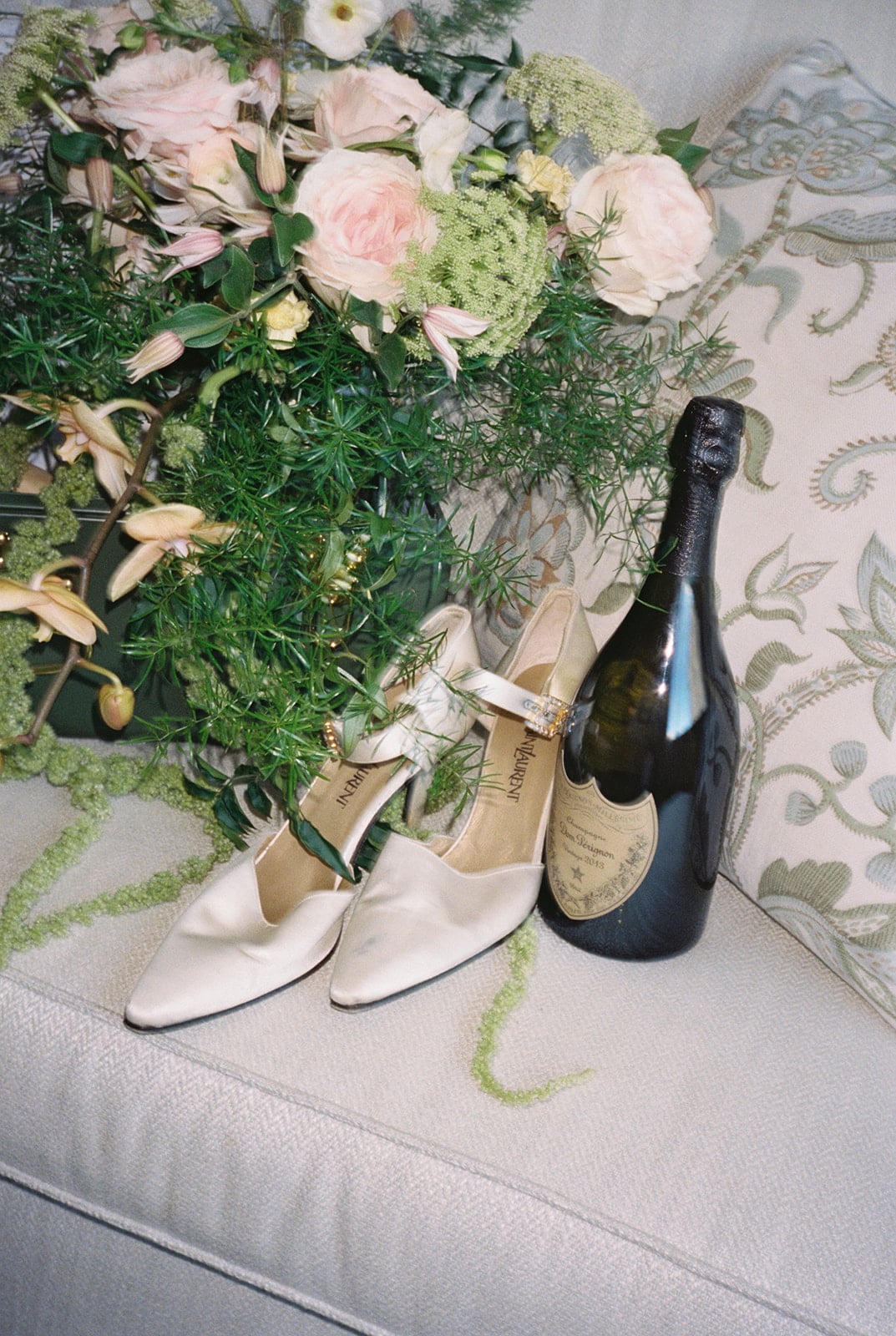 Luxurious YSL heels, Dom Pérignon champagne, and a rose bouquet for a special New Orleans stay.
