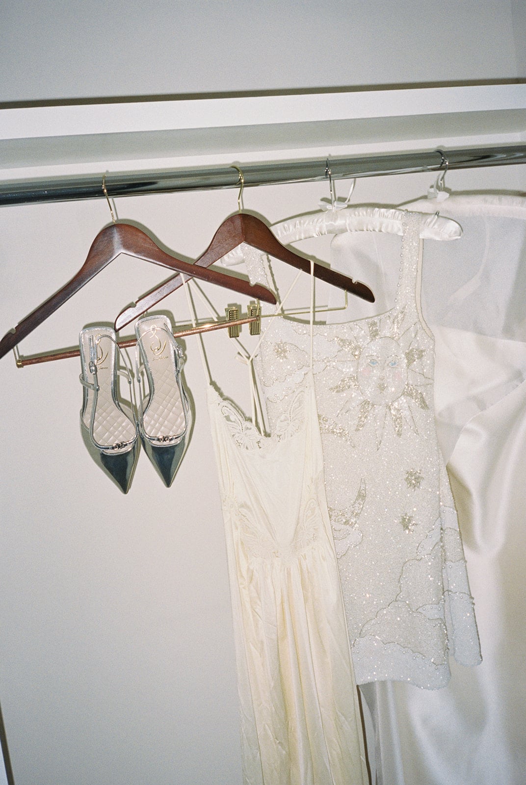 Festive beaded sun dress, elegant slip, and silver heels in a New Orleans guest closet