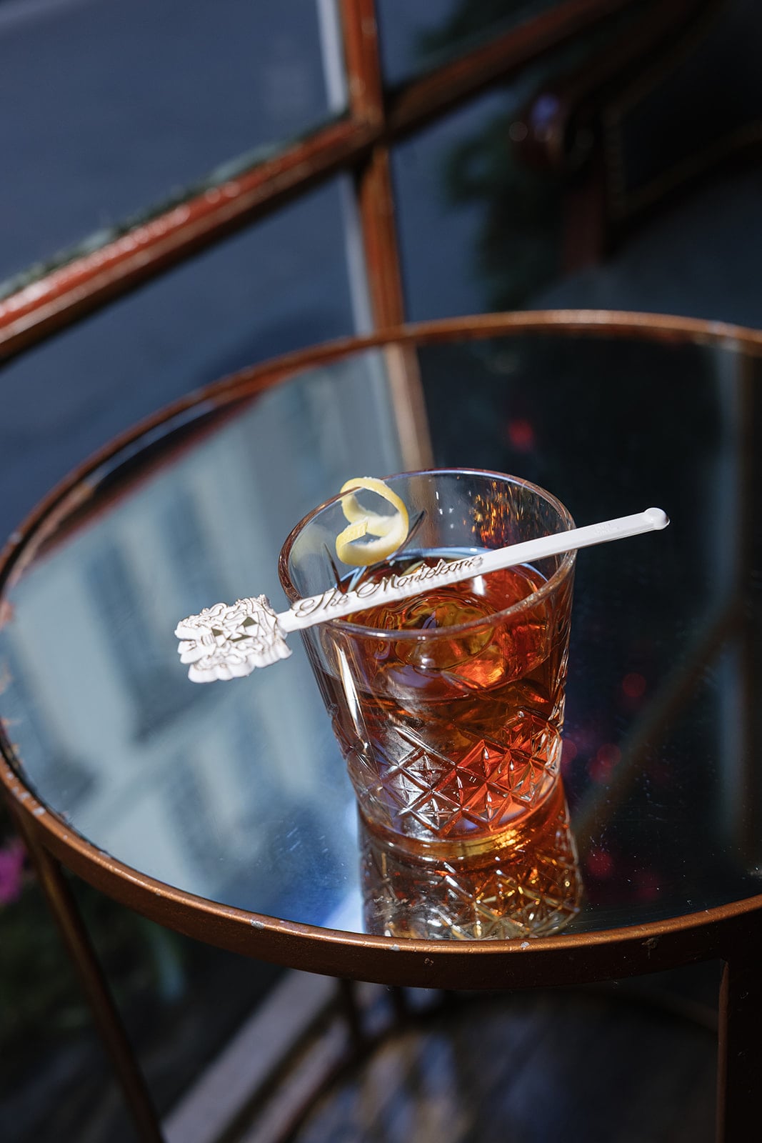 Classic New Orleans cocktail from The Manderley with a lemon peel and alligator stir stick.