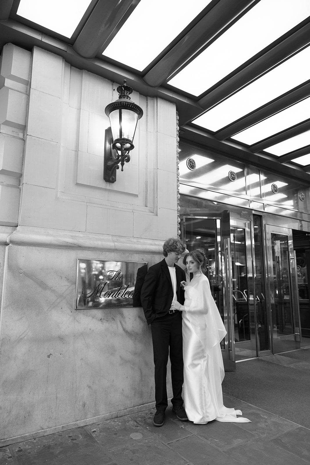 Elegant couple outside The Monteleone Hotel entrance, a historic luxury New Orleans landmark.