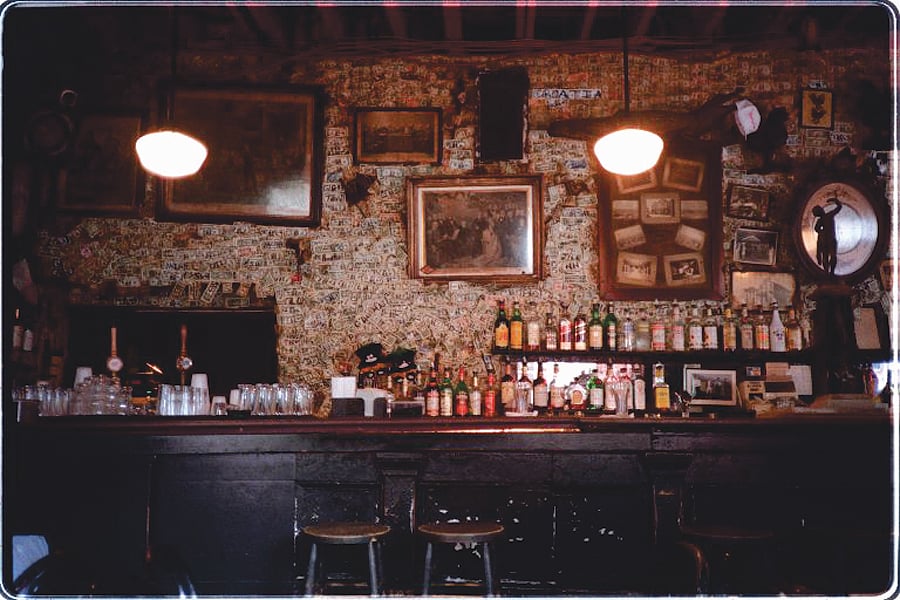 Signed dollar bills paper the back wall of this ancient bar in New Orleans