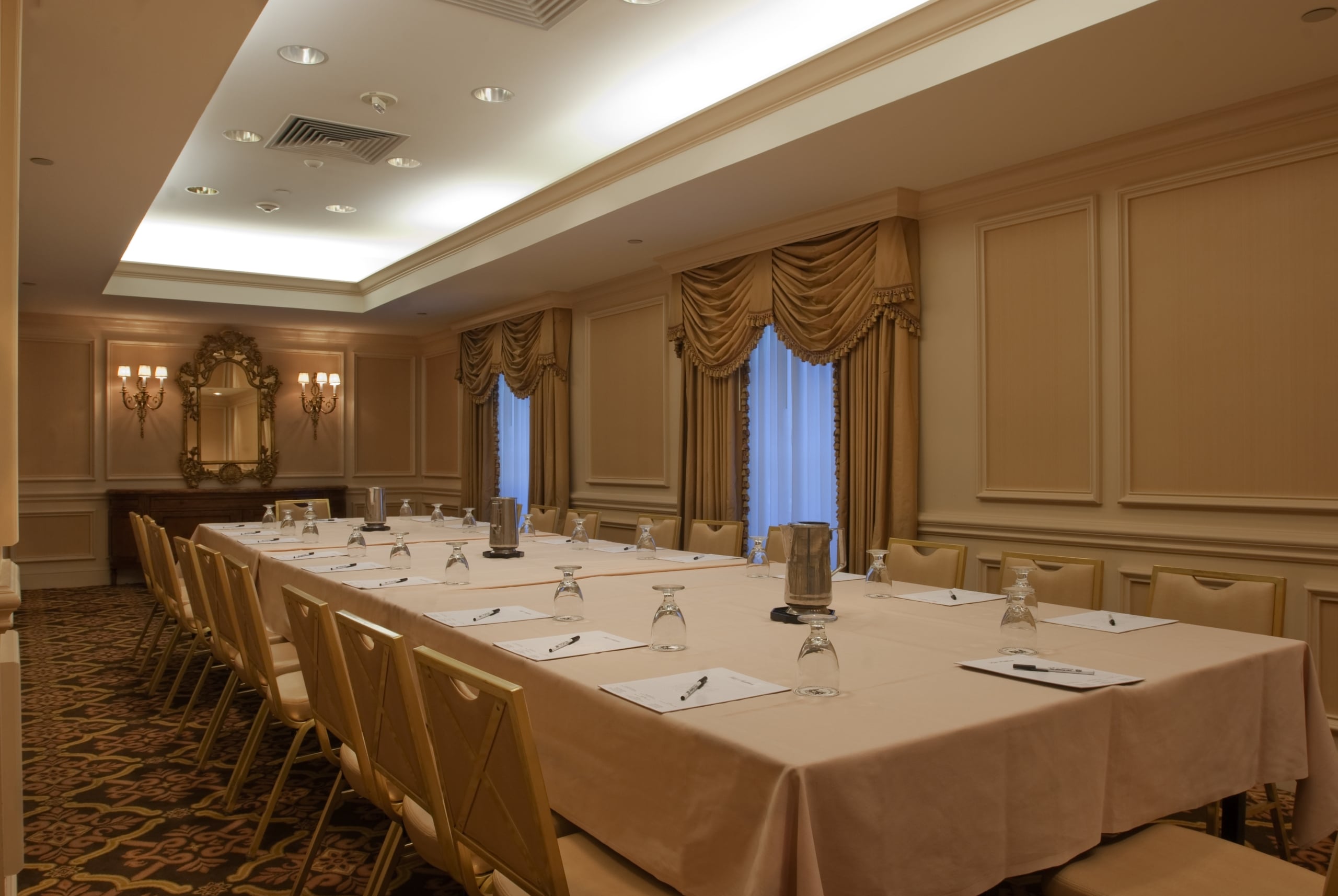 Elegant meeting room in a New Orleans hotel with a long table set for a conference.