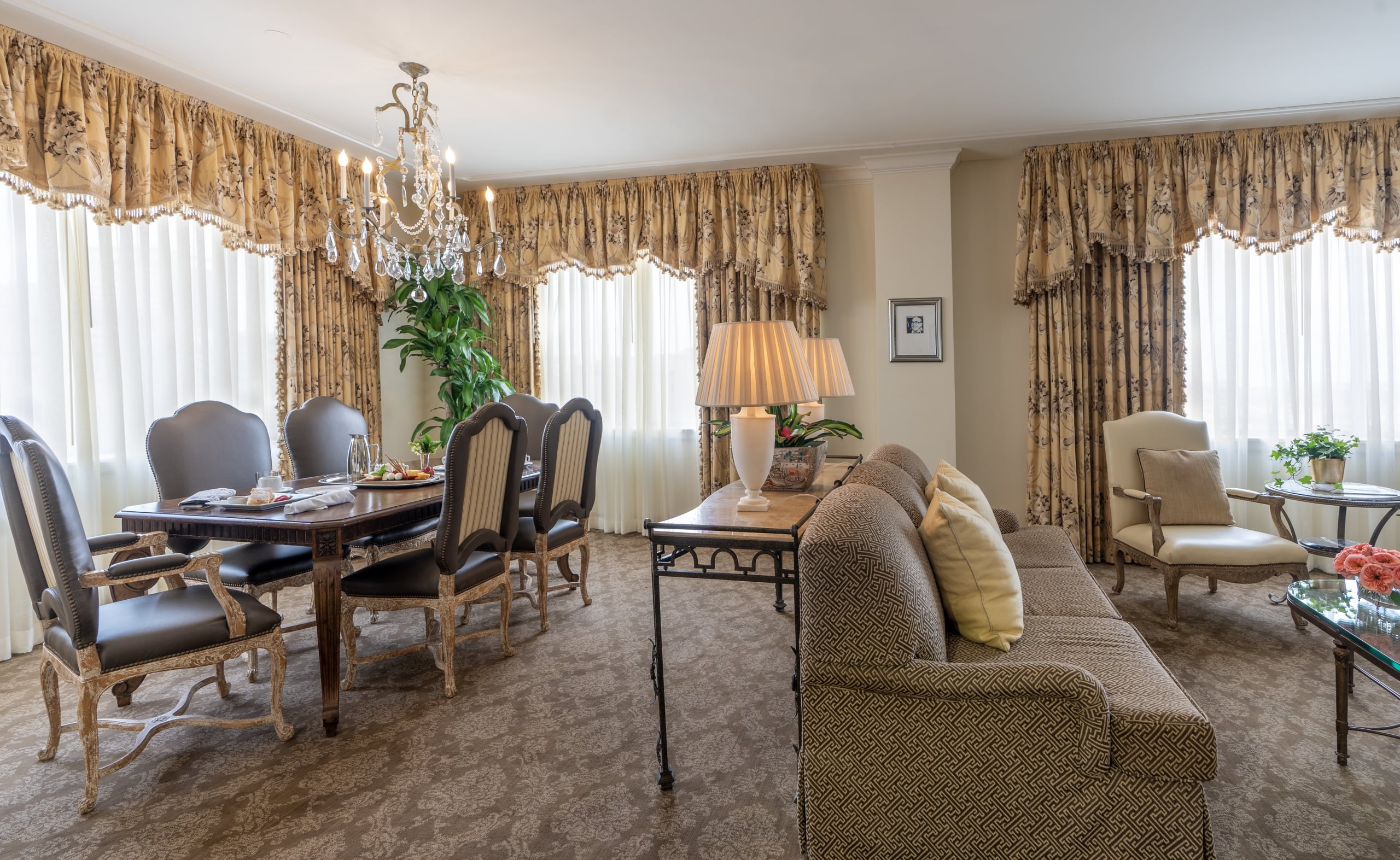 Elegant hotel suite in New Orleans featuring a formal dining area and comfortable living space.