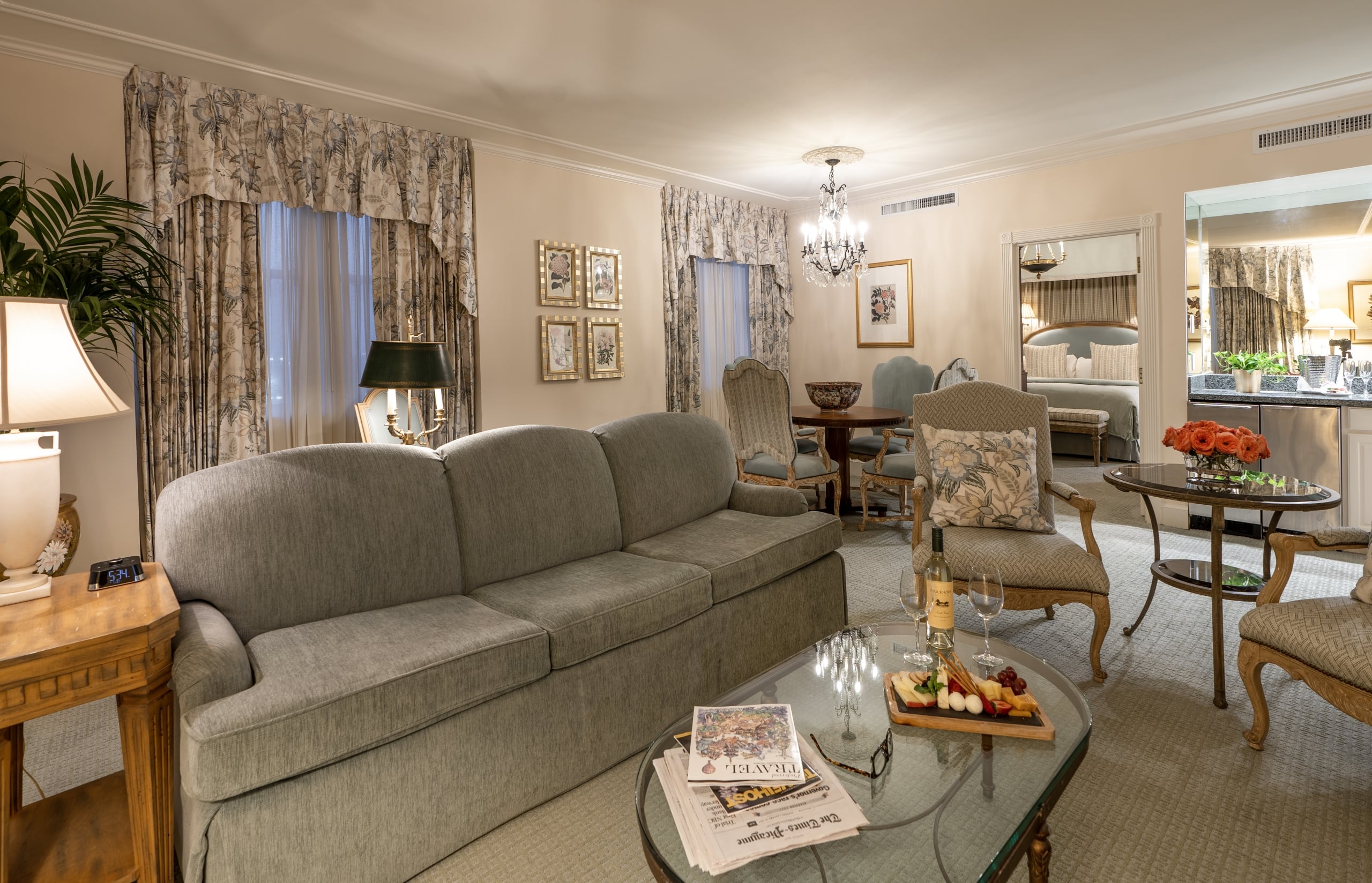 Luxurious hotel suite with a cozy living area, dining space, and elegant bedroom, perfect for a New Orleans getaway.