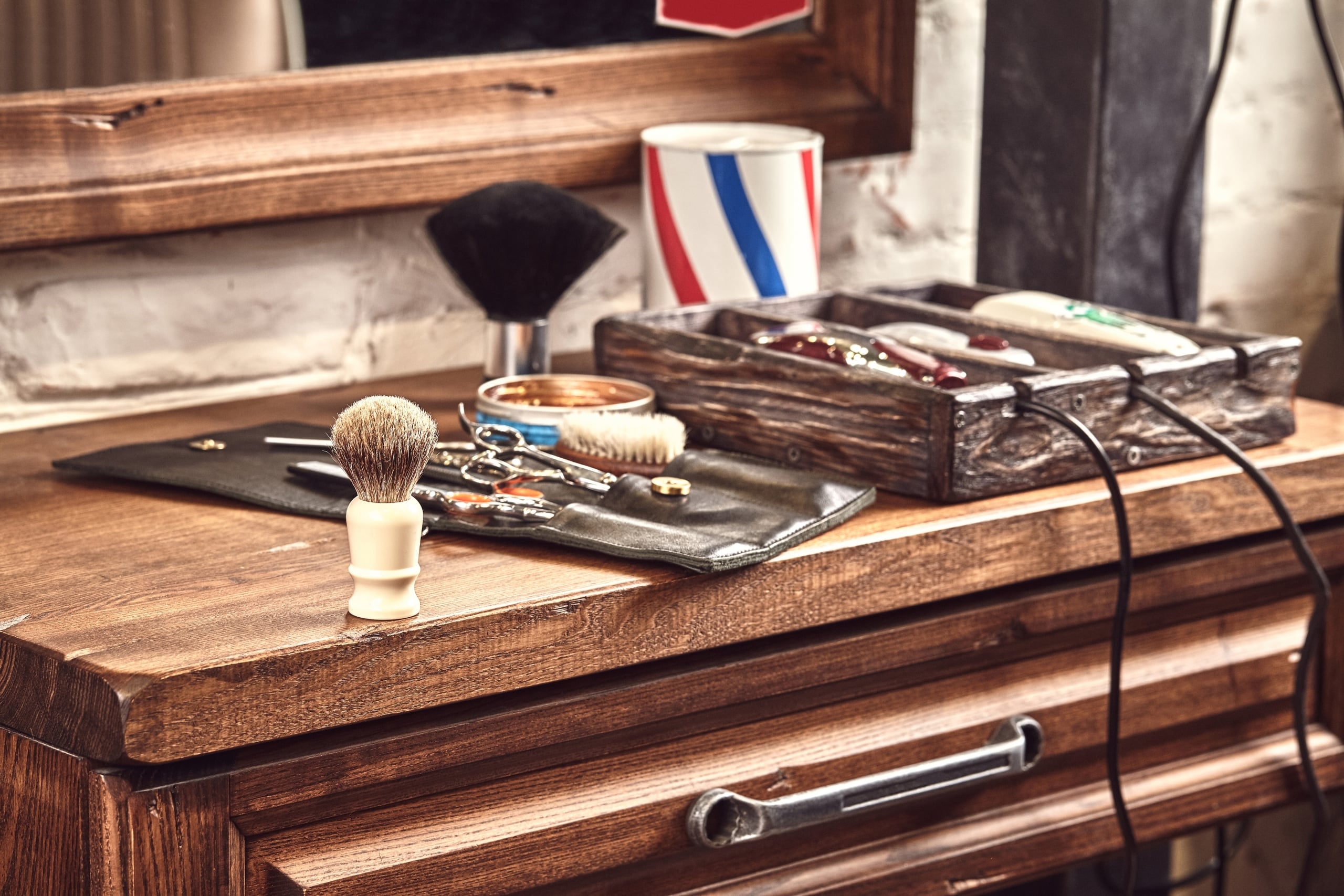 Classic barber tools on a wooden counter in a stylish New Orleans suite.