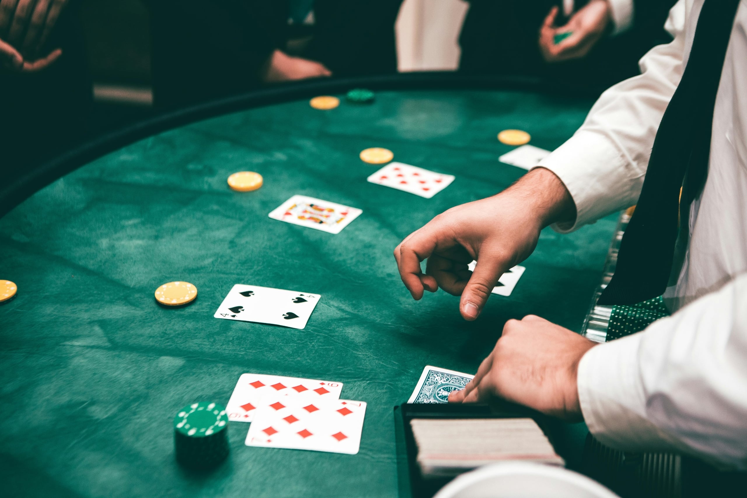 Lively poker game with a dealer, playing cards, and chips on a green table in New Orleans.