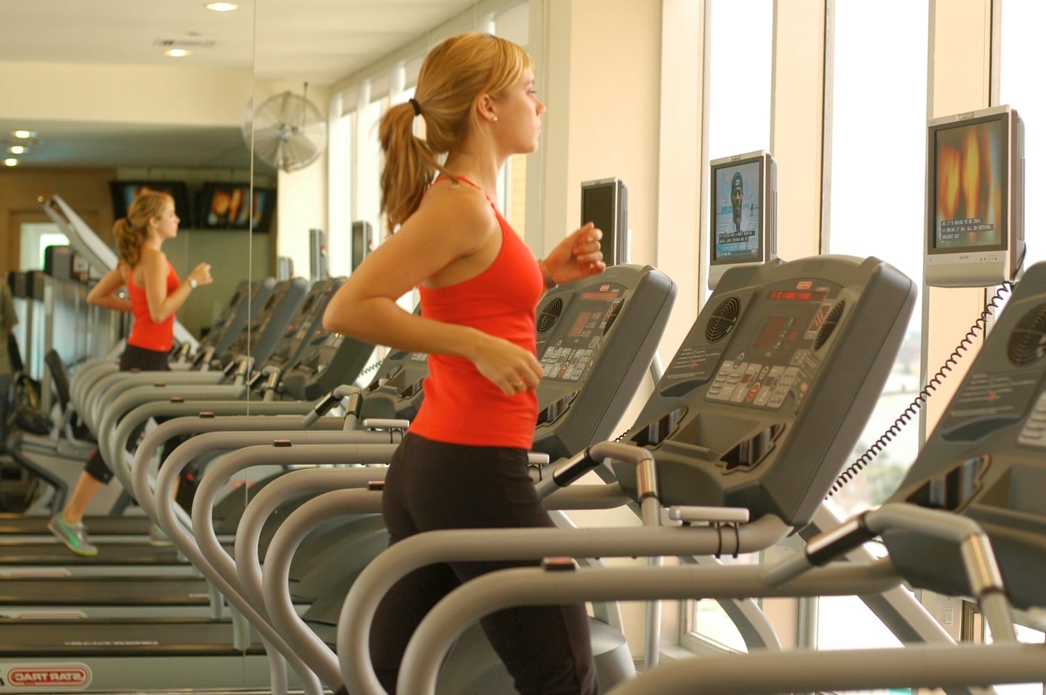 Guest exercising on a treadmill in a New Orleans hotel fitness center.