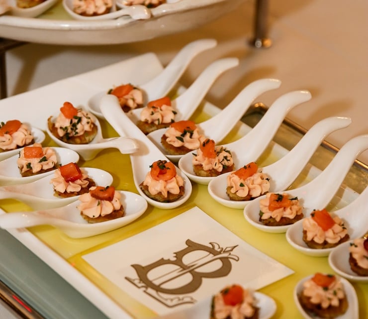 A tray of small appetizers on spoons